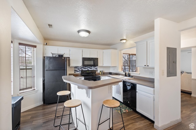 984 N Independence Ave W, Provo, UT 84604 - kitchen featuring a kitchen island, white cabinets, electric panel, dark wood-style floors, and black appliances