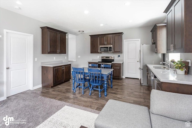 5402 W Mammoth Peak Pl, Herriman, UT 84096 - kitchen featuring stainless steel appliances, dark brown cabinets, a sink, light countertops, and dark wood-type flooring