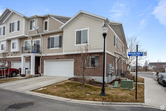 5402 W Mammoth Peak Pl, Herriman, UT 84096 - view of property featuring concrete driveway, a garage, and brick siding