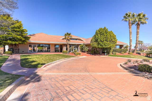 1163 W Sunrise Cir, Washington, UT 84780 - view of front of property with a front yard, a tiled roof, and stucco siding