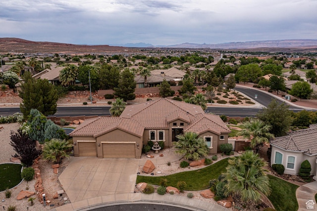drone / aerial view featuring a residential view and a mountain view