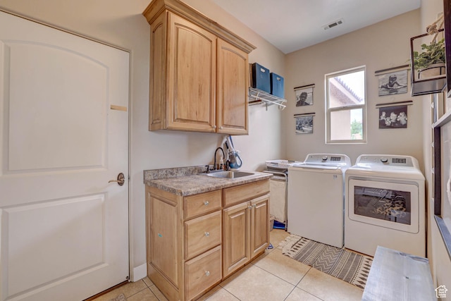 1163 W Sunrise Cir, Washington, UT 84780 - laundry area featuring washer and clothes dryer, light tile patterned floors, visible vents, cabinet space, and a sink