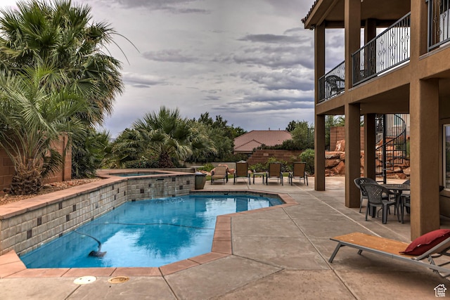 1163 W Sunrise Cir, Washington, UT 84780 - view of swimming pool featuring a fenced in pool, an in ground hot tub, stairs, a patio area, and outdoor dining space