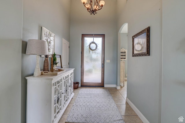1163 W Sunrise Cir, Washington, UT 84780 - entryway featuring arched walkways, a chandelier, light tile patterned flooring, a high ceiling, and baseboards