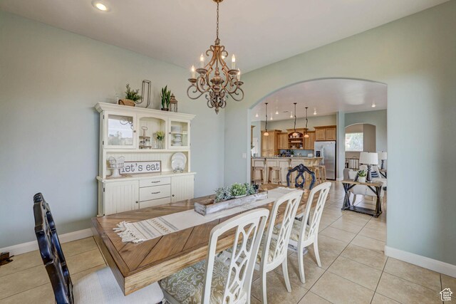 1163 W Sunrise Cir, Washington, UT 84780 - dining room featuring arched walkways, light tile patterned floors, recessed lighting, and baseboards
