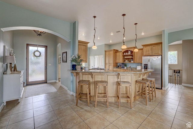 1163 W Sunrise Cir, Washington, UT 84780 - kitchen with pendant lighting, open shelves, light stone countertops, stainless steel fridge, and a peninsula