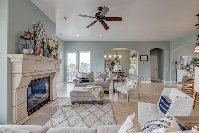1163 W Sunrise Cir, Washington, UT 84780 - living area featuring light tile patterned floors, baseboards, arched walkways, a glass covered fireplace, and recessed lighting
