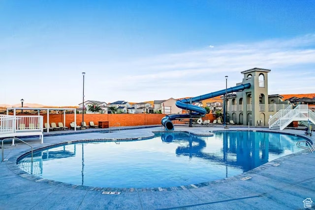 1466 N Arena Roja Dr, Washington, UT 84780 - pool featuring a residential view, fence, and a water slide