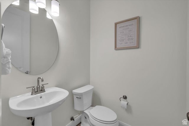 1466 N Arena Roja Dr, Washington, UT 84780 - bathroom featuring toilet, baseboards, and a sink