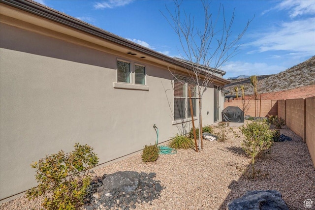 1466 N Arena Roja Dr, Washington, UT 84780 - view of side of property with a fenced backyard and stucco siding