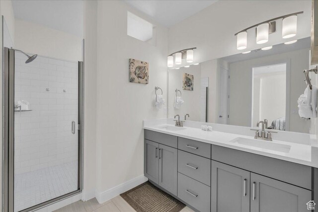 1466 N Arena Roja Dr, Washington, UT 84780 - bathroom with a shower stall, double vanity, a sink, and baseboards