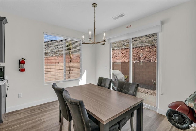 1466 N Arena Roja Dr, Washington, UT 84780 - dining room featuring a notable chandelier, wood finished floors, and baseboards
