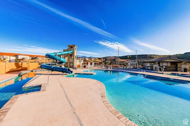 1466 N Arena Roja Dr, Washington, UT 84780 - pool with a patio, a water slide, and fence