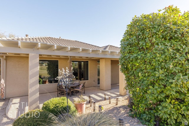 1109 N Ventana Dr, Washington, UT 84780 - rear view of house with a patio, a tile roof, and stucco siding