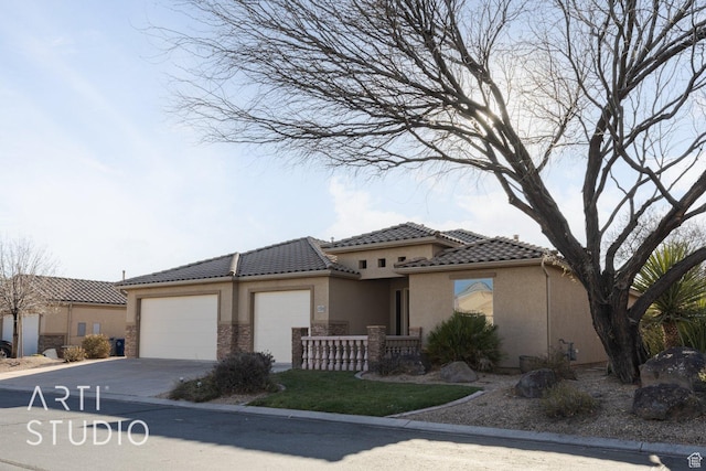 1109 N Ventana Dr, Washington, UT 84780 - mediterranean / spanish home with a garage, concrete driveway, a tile roof, and stucco siding