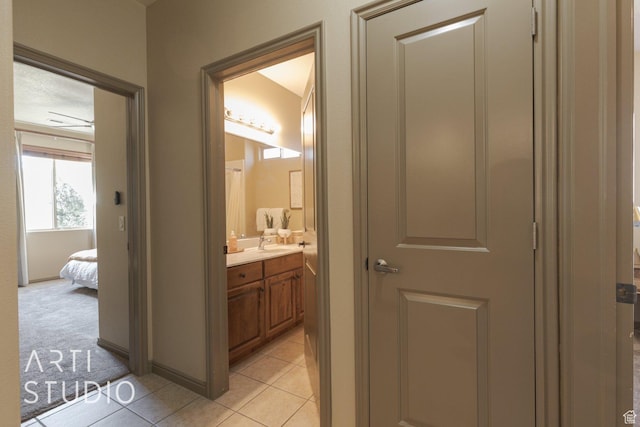 1109 N Ventana Dr, Washington, UT 84780 - hall with light carpet, a sink, and light tile patterned floors