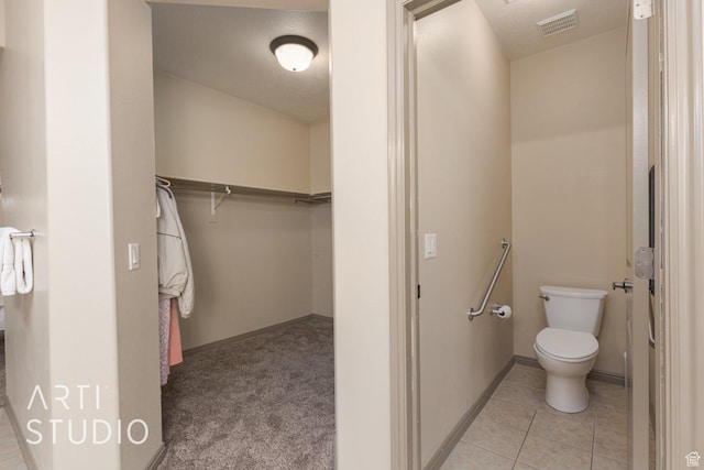 1109 N Ventana Dr, Washington, UT 84780 - bathroom with a walk in closet, visible vents, toilet, baseboards, and tile patterned floors