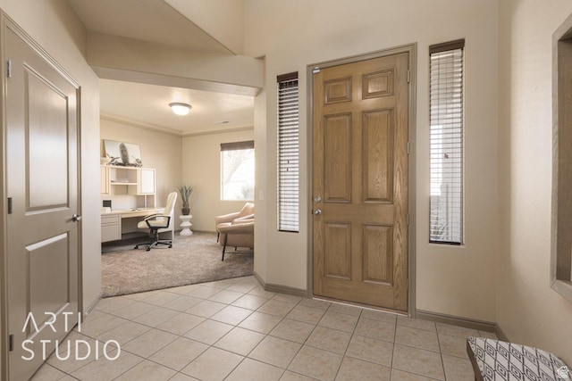 1109 N Ventana Dr, Washington, UT 84780 - foyer entrance with light tile patterned floors, baseboards, built in study area, and light colored carpet