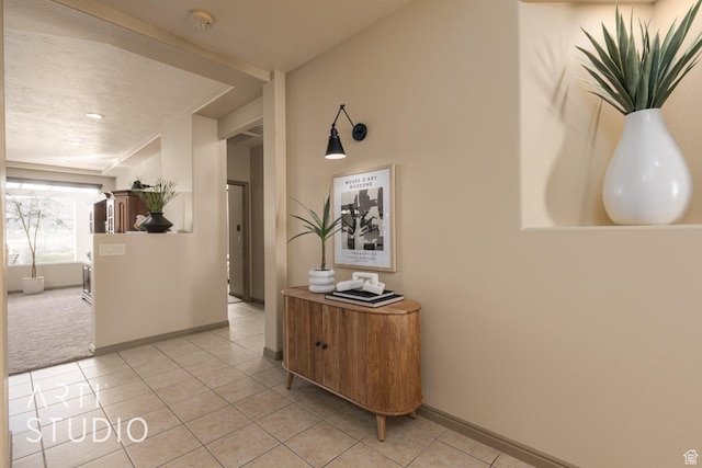 1109 N Ventana Dr, Washington, UT 84780 - hall featuring light tile patterned floors, light carpet, and baseboards