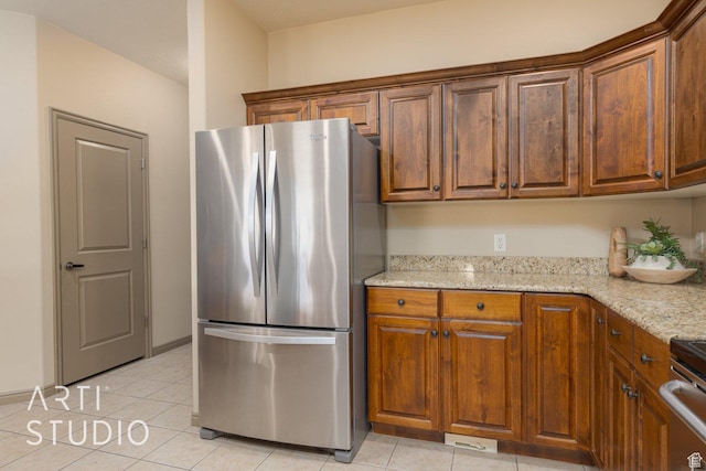 1109 N Ventana Dr, Washington, UT 84780 - kitchen featuring appliances with stainless steel finishes, brown cabinetry, and light stone countertops