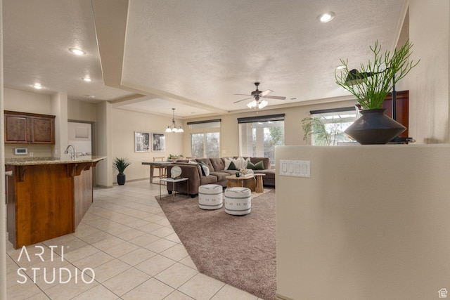1109 N Ventana Dr, Washington, UT 84780 - living area featuring light tile patterned floors, a textured ceiling, ceiling fan with notable chandelier, and a wealth of natural light