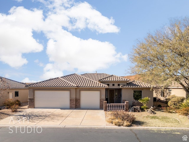 1109 N Ventana Dr, Washington, UT 84780 - mediterranean / spanish-style house with a garage, driveway, stone siding, a tiled roof, and stucco siding