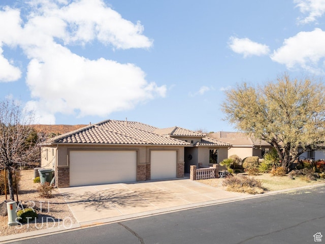 1109 N Ventana Dr, Washington, UT 84780 - view of front of house featuring a garage, driveway, a tile roof, and stucco siding