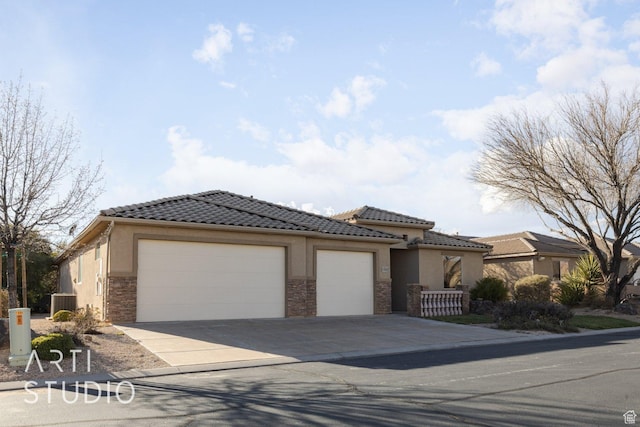 1109 N Ventana Dr, Washington, UT 84780 - view of front facade with a garage, a tile roof, and stucco siding