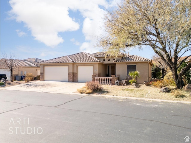 1109 N Ventana Dr, Washington, UT 84780 - view of front of property with a garage, a tiled roof, concrete driveway, and stucco siding