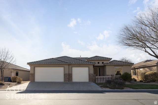 1109 N Ventana Dr, Washington, UT 84780 - view of front of house with concrete driveway, an attached garage, a tile roof, and stucco siding