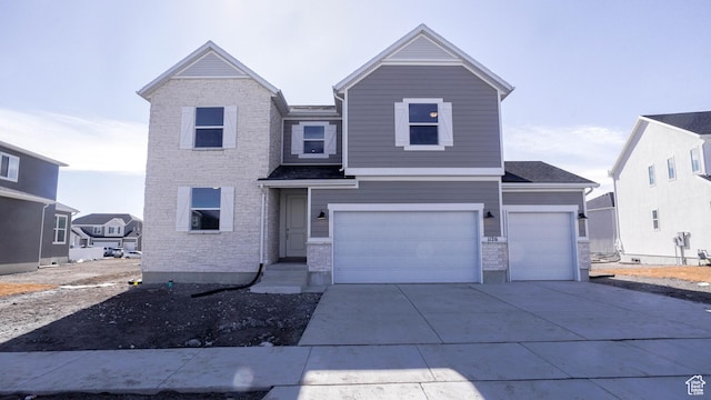 traditional home with concrete driveway and an attached garage