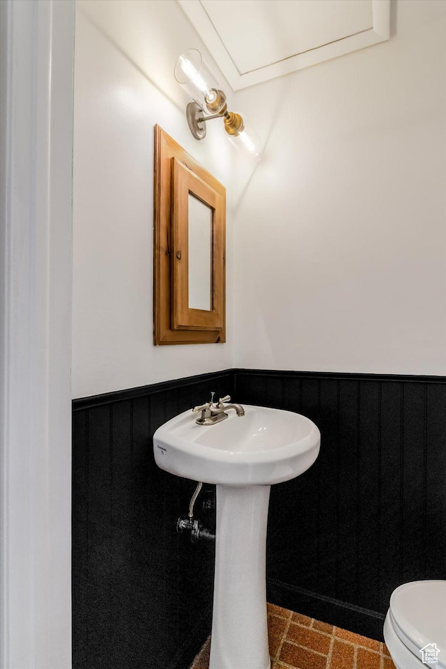 1417 E 700 S, Provo, UT 84606 - half bathroom with brick floor, wainscoting, and toilet