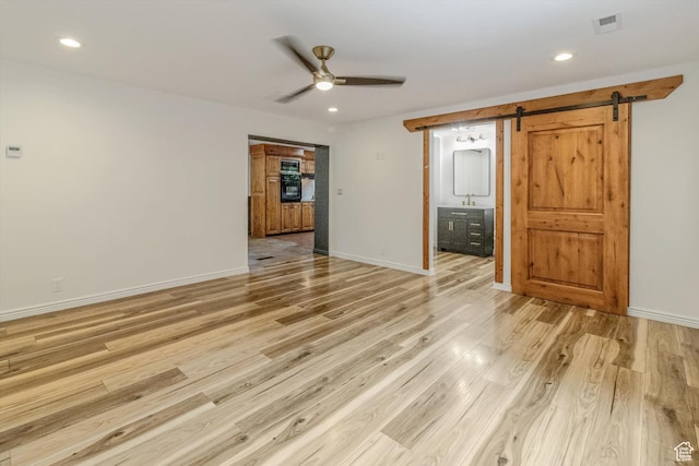 1417 E 700 S, Provo, UT 84606 - empty room with light wood finished floors, a barn door, recessed lighting, and baseboards