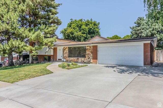1417 E 700 S, Provo, UT 84606 - split level home featuring a garage, stone siding, concrete driveway, and a front yard