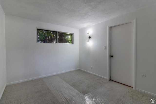 1417 E 700 S, Provo, UT 84606 - empty room featuring a textured ceiling, baseboards, and light colored carpet