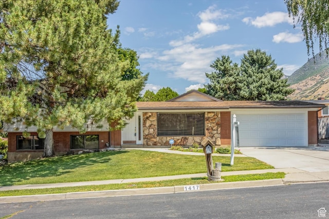 1417 E 700 S, Provo, UT 84606 - view of front of property with a mountain view, a garage, stone siding, driveway, and a front yard