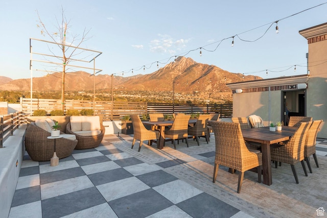 2250 E Murray Holladay Rd Unit 205, Holladay, UT 84117 - view of patio with outdoor dining area, outdoor lounge area, fence, and a mountain view