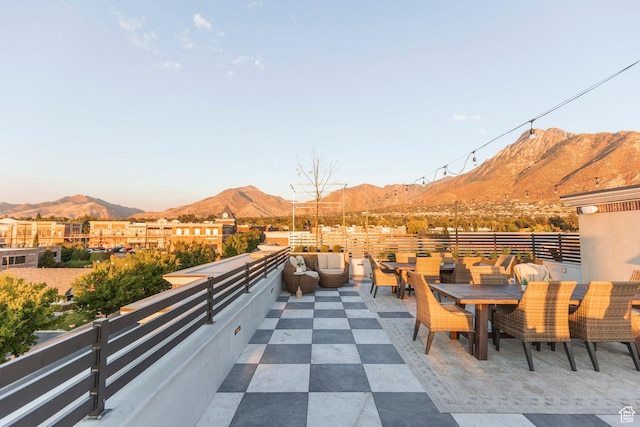 2250 E Murray Holladay Rd Unit 205, Holladay, UT 84117 - view of patio with outdoor dining space, a balcony, and a mountain view
