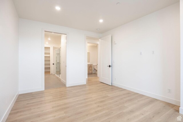 2250 E Murray Holladay Rd Unit 205, Holladay, UT 84117 - unfurnished room with baseboards, recessed lighting, and light wood-style floors