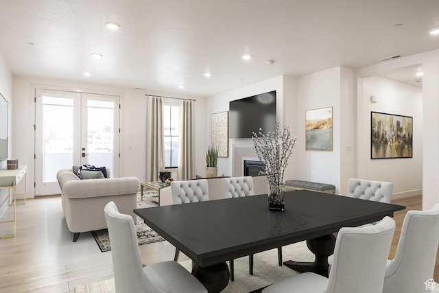 2250 E Murray Holladay Rd Unit 205, Holladay, UT 84117 - dining space with light wood-style floors, recessed lighting, visible vents, and a glass covered fireplace