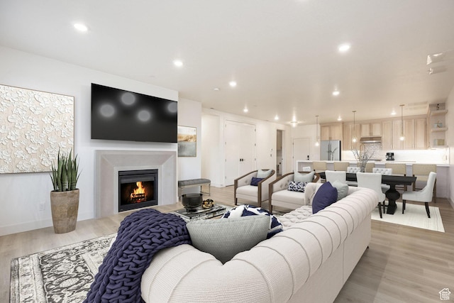 2250 E Murray Holladay Rd Unit 205, Holladay, UT 84117 - living room featuring light wood-style floors, recessed lighting, and a lit fireplace