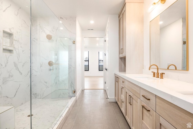2250 E Murray Holladay Rd Unit 205, Holladay, UT 84117 - full bathroom with a marble finish shower, double vanity, visible vents, a sink, and baseboards