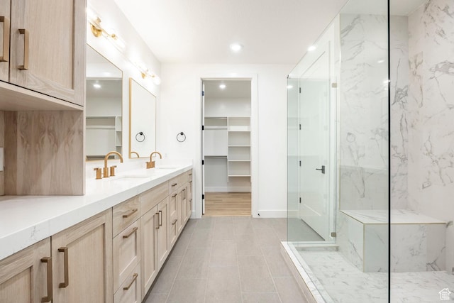 2250 E Murray Holladay Rd Unit 205, Holladay, UT 84117 - full bathroom with double vanity, a sink, a marble finish shower, and a walk in closet