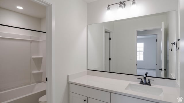 bathroom featuring recessed lighting, shower / bath combination, vanity, and toilet