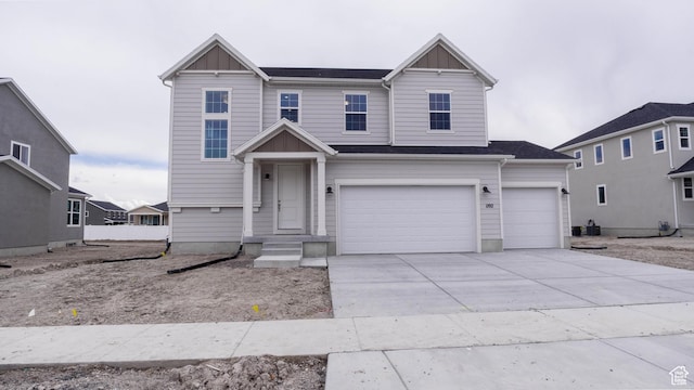 view of front facade with a garage, driveway, and board and batten siding