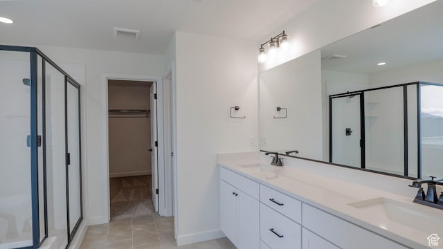 bathroom featuring a shower stall, a sink, and visible vents