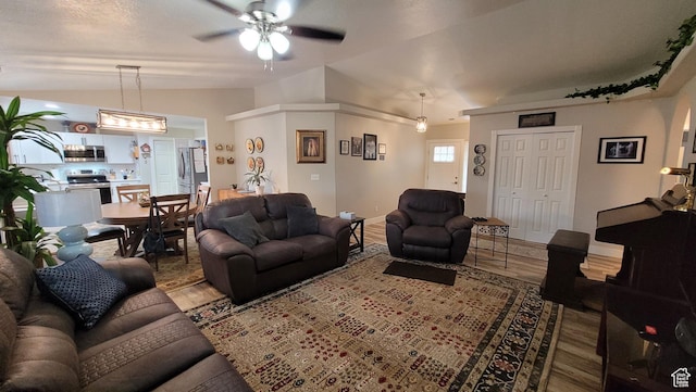 657 W 150 S, Hurricane, UT 84737 - living room featuring vaulted ceiling, ceiling fan, and wood finished floors