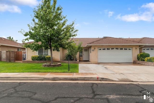single story home with a tile roof, stucco siding, an attached garage, a front yard, and driveway