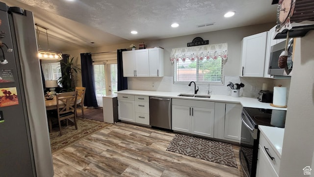 657 W 150 S, Hurricane, UT 84737 - kitchen with white cabinets, stainless steel appliances, a sink, and light countertops