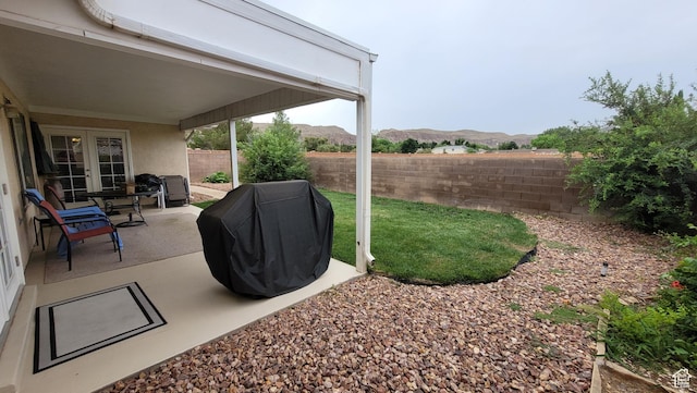 657 W 150 S, Hurricane, UT 84737 - view of yard featuring french doors, a fenced backyard, a mountain view, and a patio